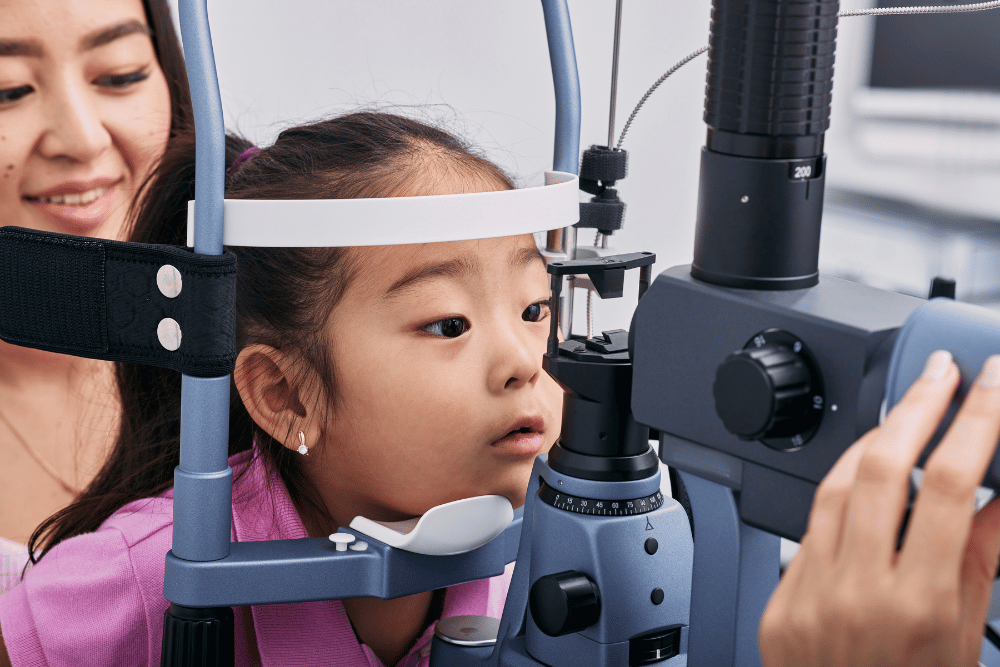 child with her mother getting an eye exam