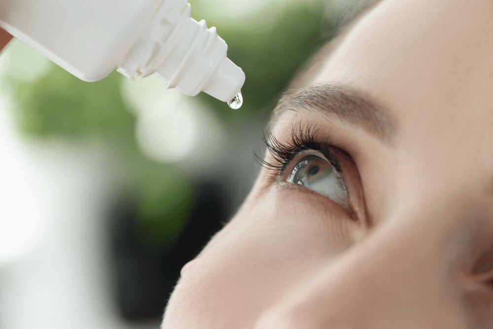 woman putting in eye drops